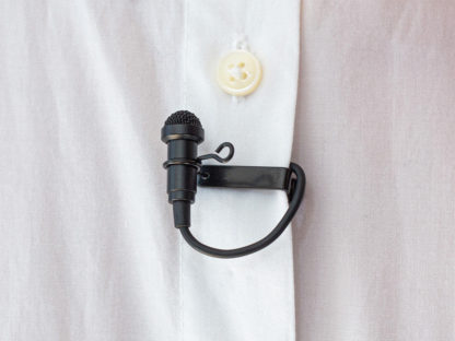 Lavalier mic in black attached to a shirt